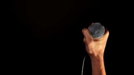 male-hand-with-microphone-isolated-on-black-1630672
