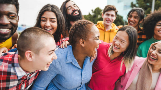 Young diverse people having fun outdoor laughing together