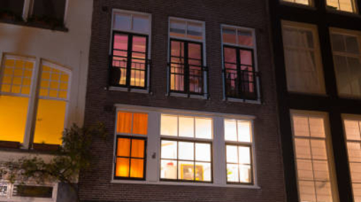 facade of a typical amsterdam canal house at night